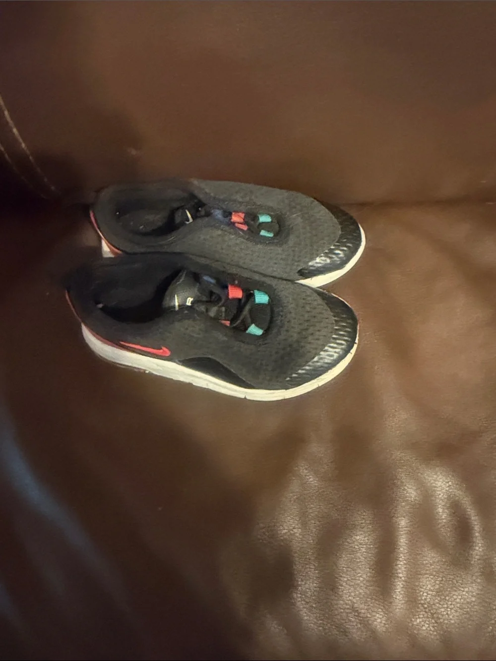 Nike Kids Black Slip-On Sneakers with Blue, Red, and Teal Accents